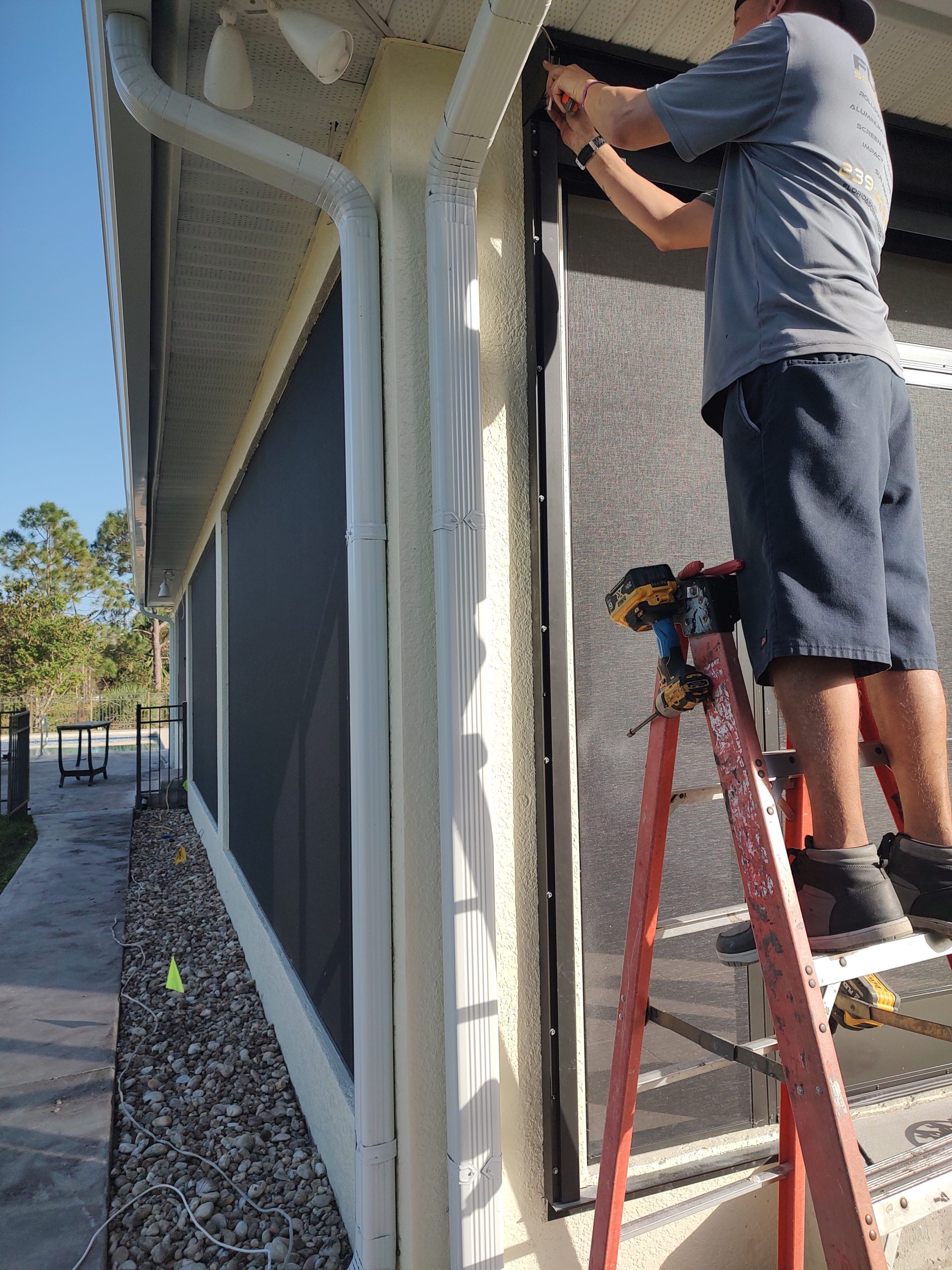 Florida Screen and Shutter technician servicing a screen system