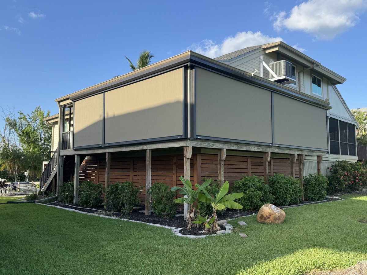 Retractable hurricane screens deployed across an elevated lanai on a Southwest Florida home